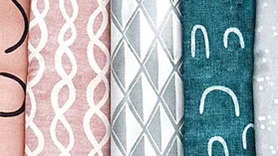 A set of 5 differently patterned fabric rolls